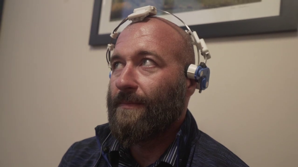 man with brain scanner on head